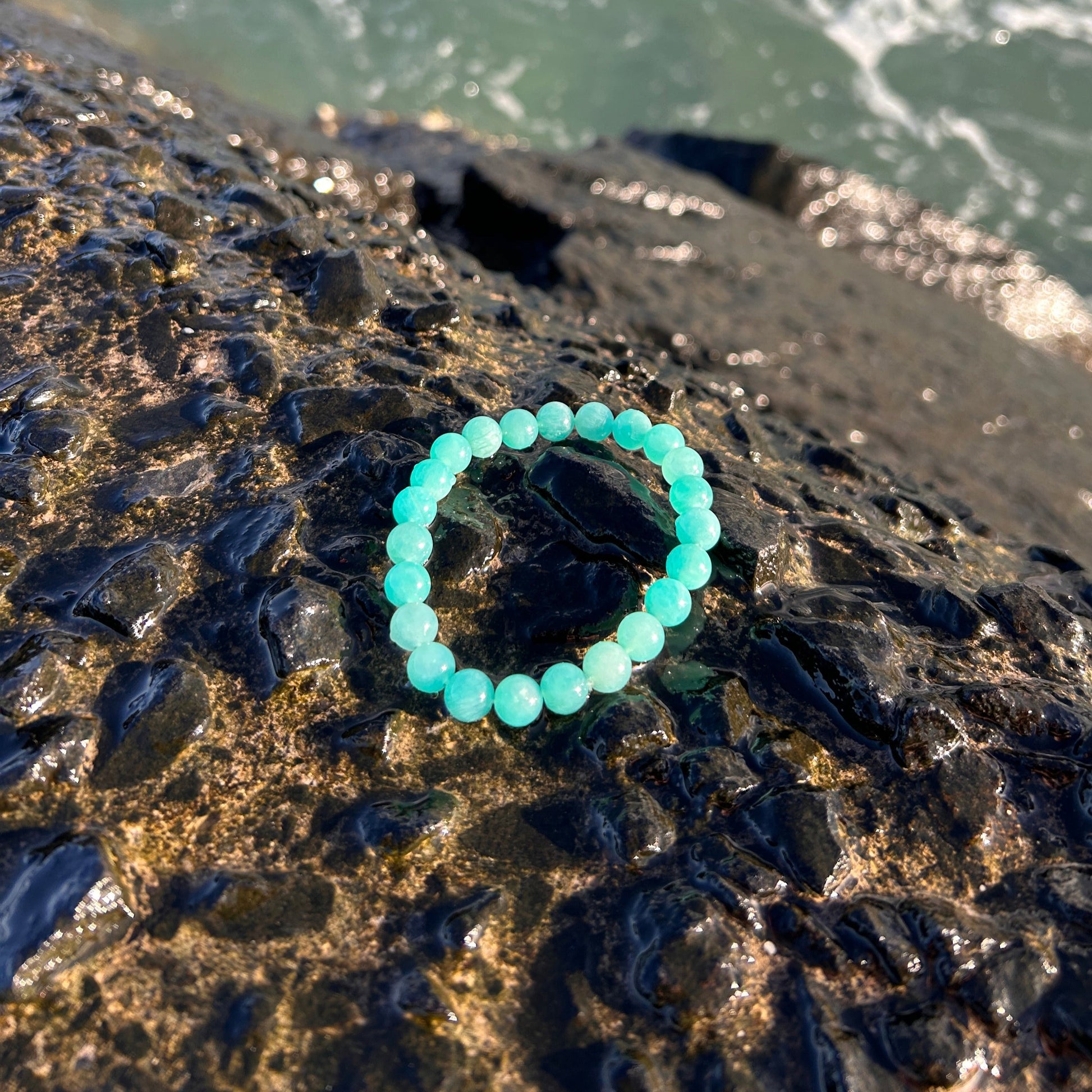 Amazonite with the pacific ocean and black lava.